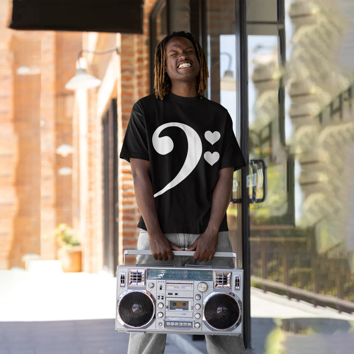 A man holding a boombox and wearing For The Love of Bass Unisex Tee, black