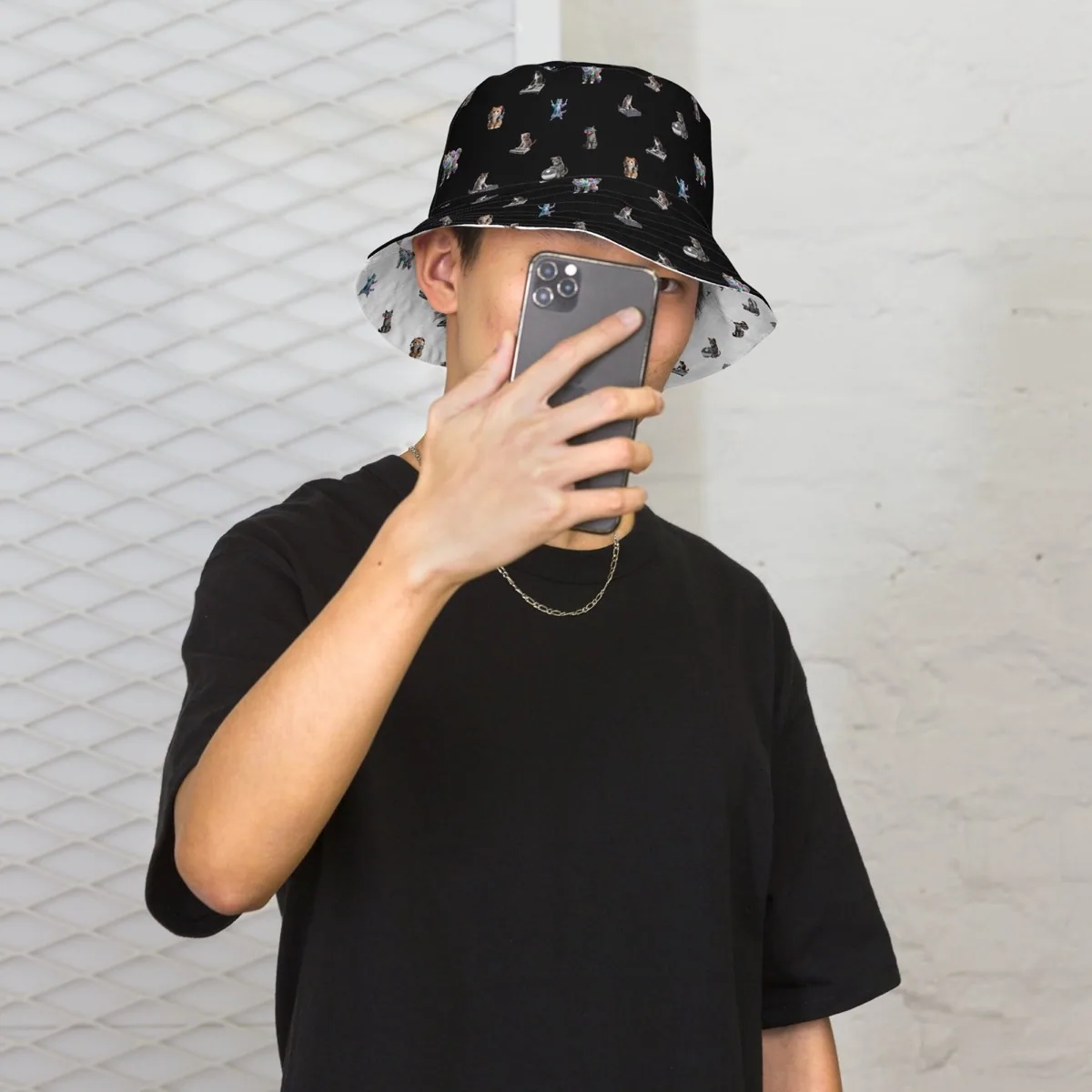A man wearing Rave Cats Reversible Bucket Hat, black side