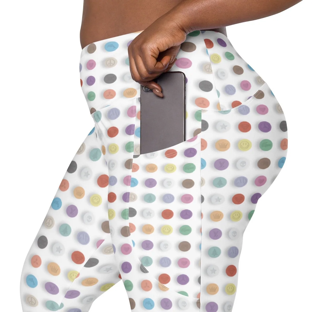 A woman putting a phone in the pocket of Taste the Rainbow Leggings with Pockets