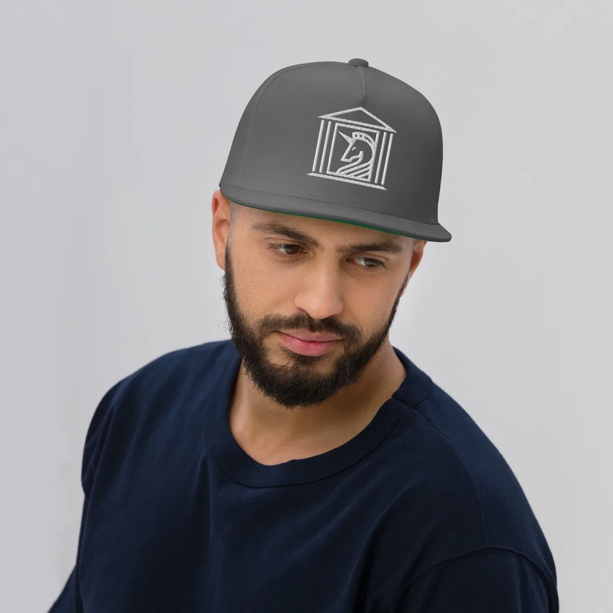 A man wearing D&B Camouflage Trucker Cap, grey